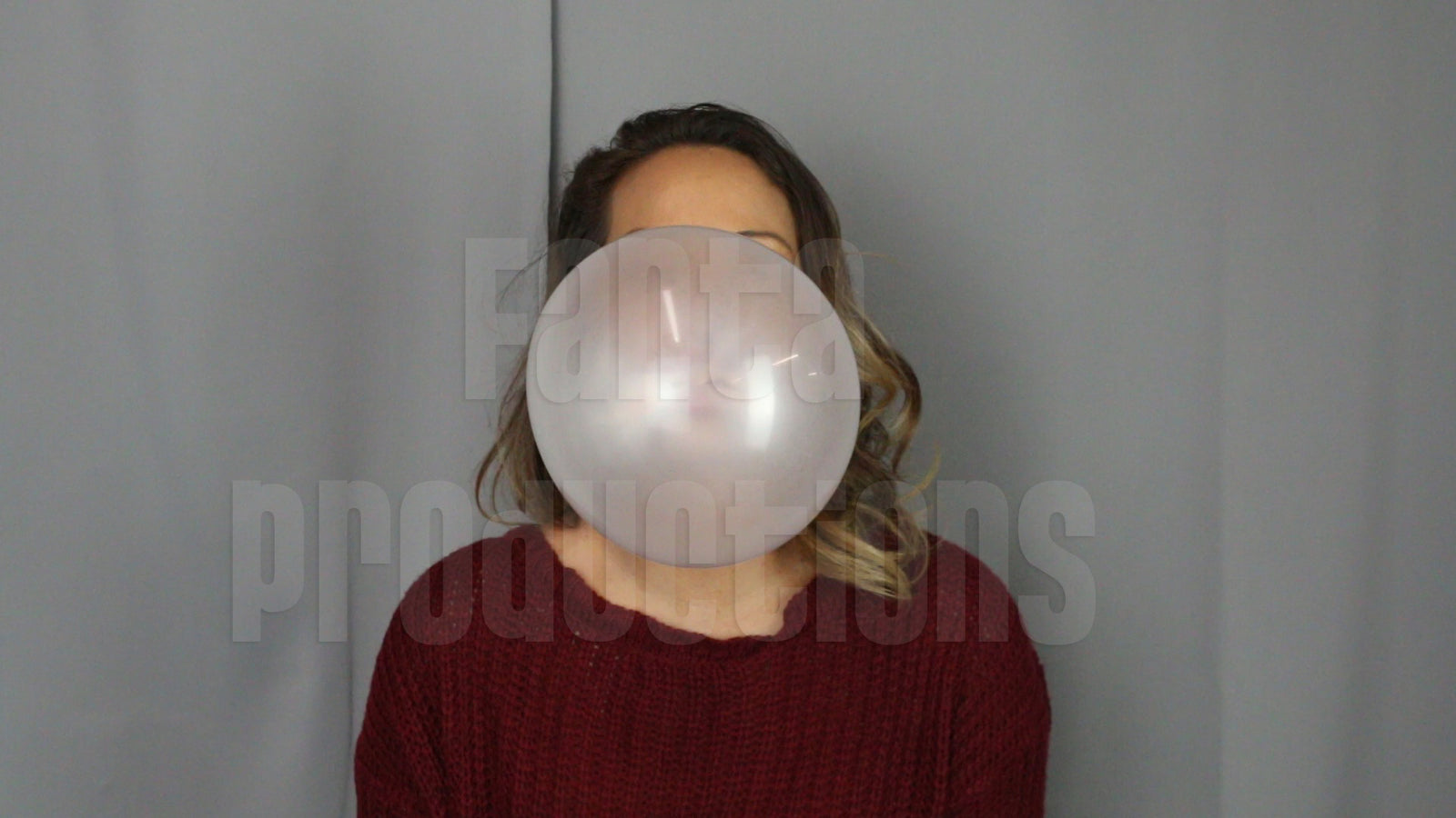 Jane Domino Blowing Bubbles in Red Sweater