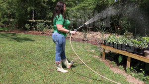 Jeanell Watering Plants in Rain Boots